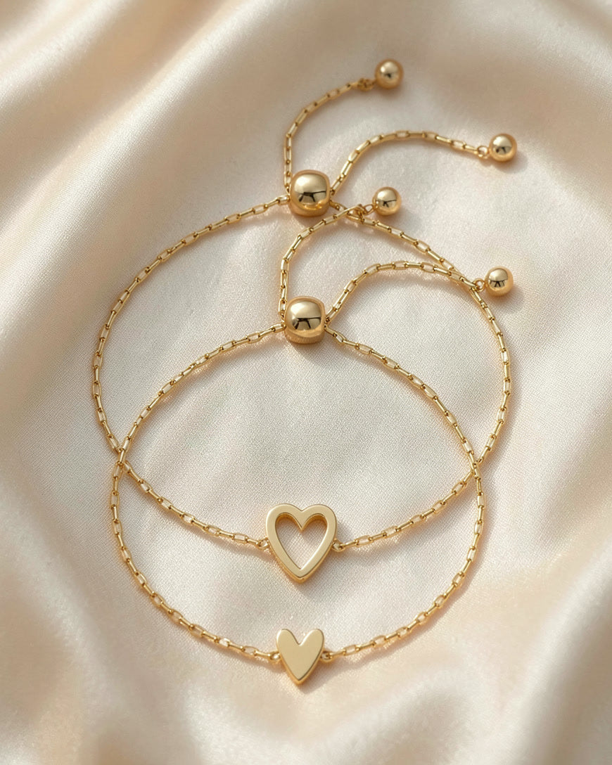 The Heart Chain bracelet pair in gold, open heart and small heart, on silk