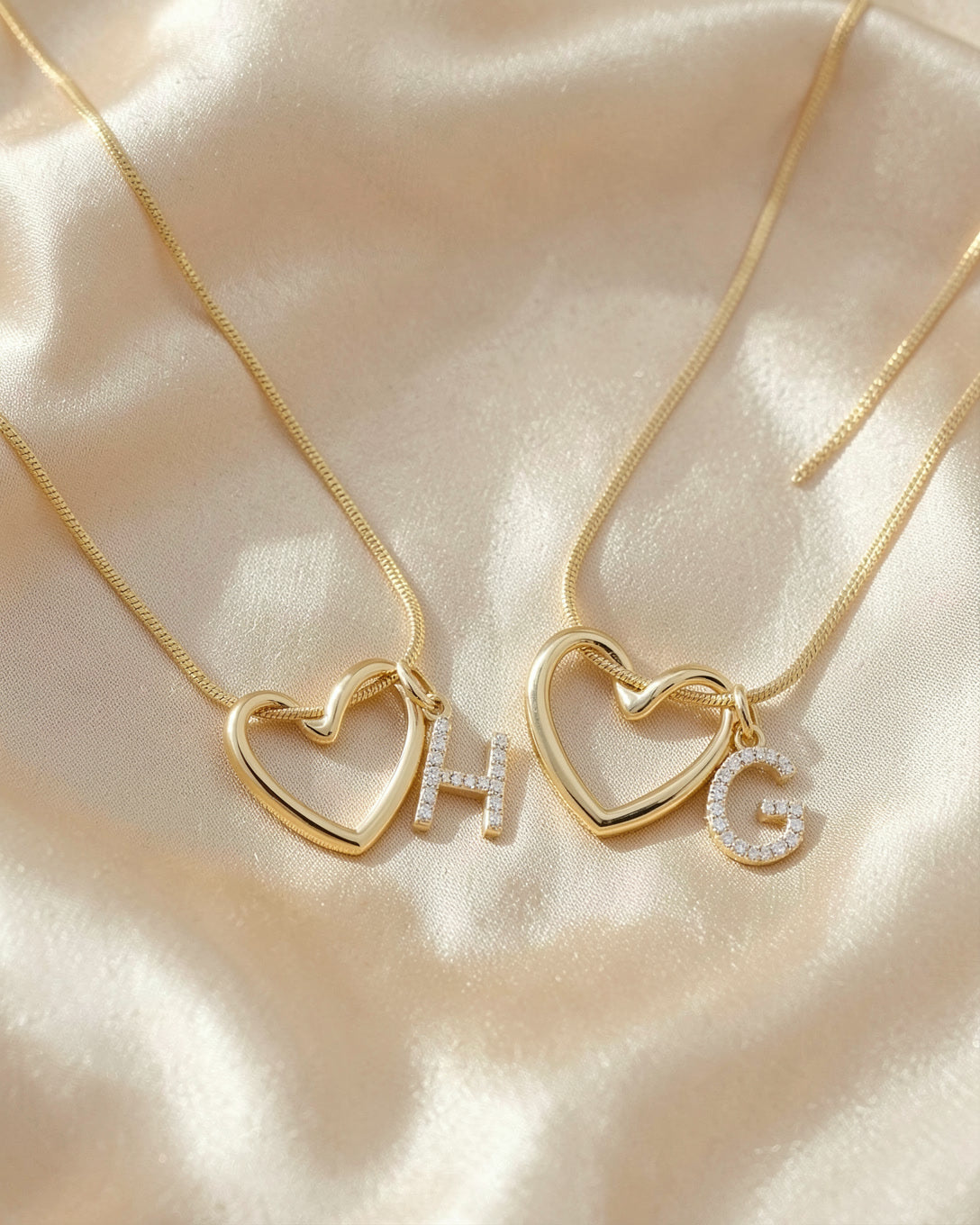Two Keepsake Heart necklaces with initials H and G