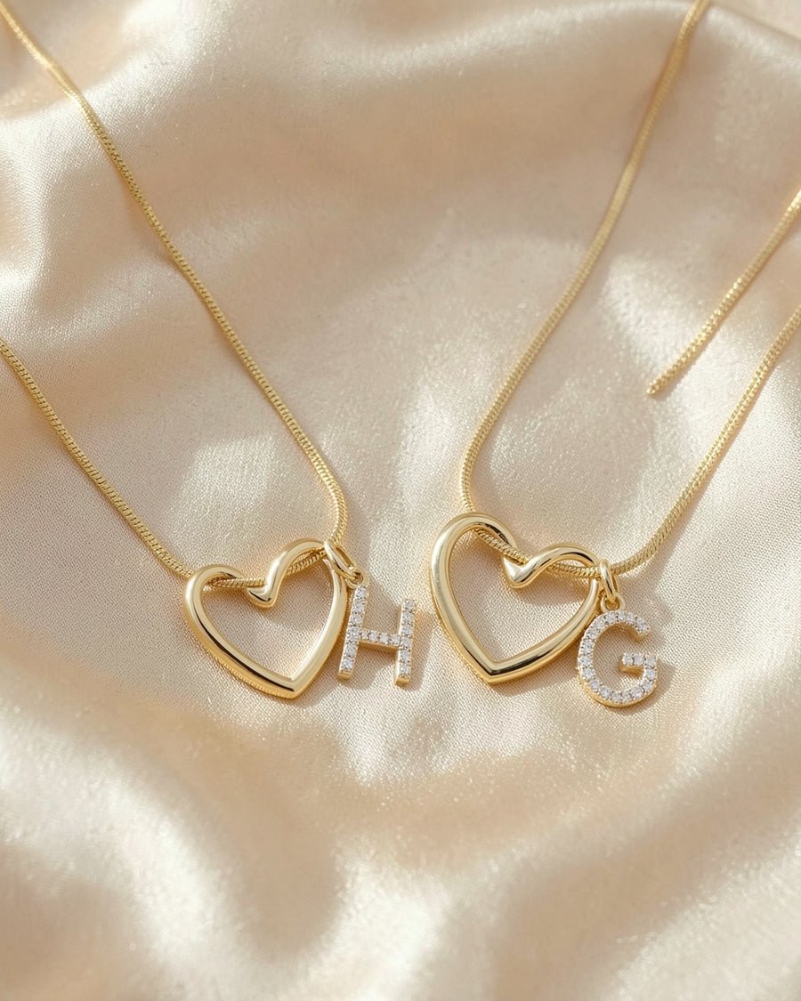 Two Keepsake Heart necklaces with initials H and G