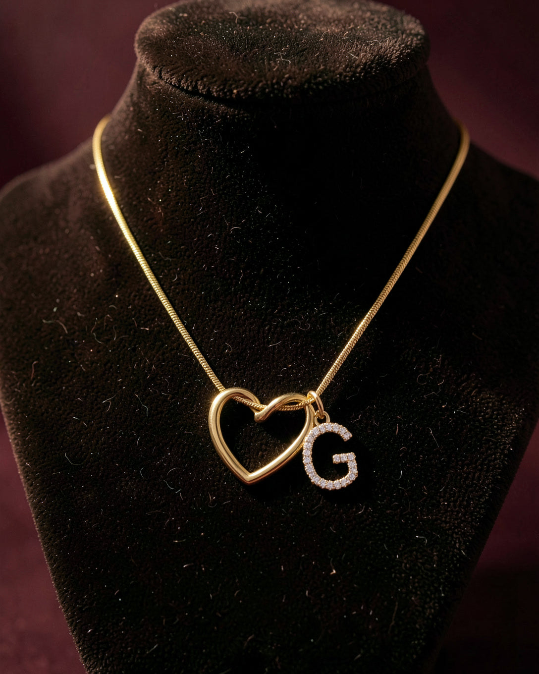 The Keepsake Heart necklace on a dark velvet bust