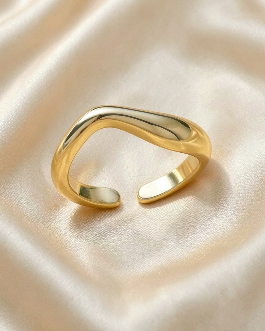 The Ripple stackable ring in gold tone on ivory silk